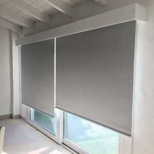 Blackout roller blinds blocking light in cozy bedroom